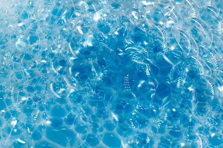 Soap foam. Background of dusty foam with bubbles of blue color for an inscription. Soap sud with copy-spaceの写真素材