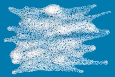 Soap foam. Background of dusty foam with bubbles of blue color for an inscription. Soap sud with copy-spaceの写真素材