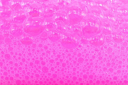 Soap foam. Background of dusty foam with bubbles of pink color for an inscription. Soap sud with...