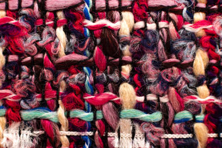 Texture of fabric from multi-colored threads for knitting. fabric for tailoring. Colored thread patternの写真素材