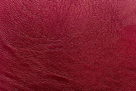 The texture of natural leather is red or burgundy. leather background
