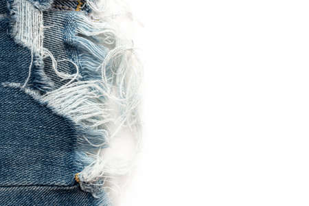 Frayed ripped jeans on a white background. Denim frame with empty space for inscription