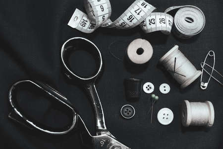 Retro tools for cutting and sewing. Needle with thread, thimble, sewing machine and scissorsの写真素材