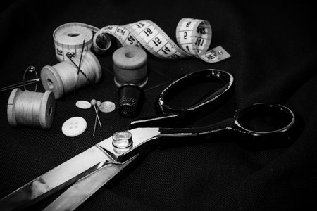 Retro tools for cutting and sewing. Needle with thread, thimble, sewing machine and scissors