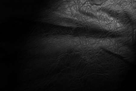Black leather texture. Abstract background of dark leather with small roughness and scuffsの写真素材
