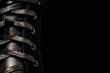 Shoe laces. Lace-up casual or sports shoes close-up on a dark background. Shoes background