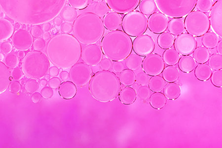 Soap foam. Background of dusty foam with bubbles of pink color for an inscription. Soap sud with...