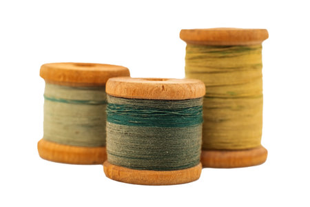 Old wooden spool of thread on a white background close-up. Threads for sewingの写真素材