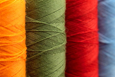 Multi-colored spools of thread close-up. Needle with thread. Seamstress or tailor's toolsの写真素材