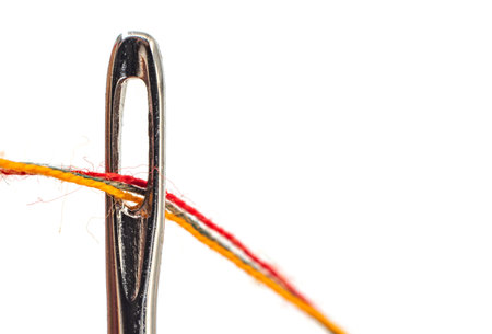 Needle and thread on a white background close-up. Needle isolate with empty space for inscription