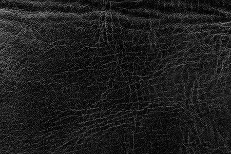 Black leather texture. Abstract background of dark leather with small roughness and scuffsの写真素材