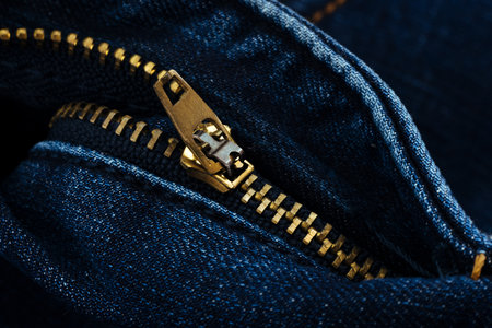 Closeup of zipper in blue jeans. Zipper with lock. A piece of denim