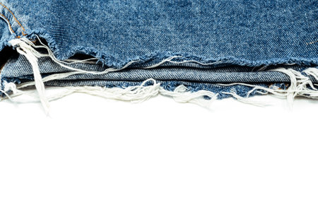 Frayed ripped jeans on a white background. Denim frame with empty space for inscriptionの写真素材