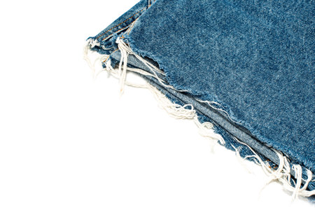 Frayed ripped jeans on a white background. Denim frame with empty space for inscriptionの写真素材