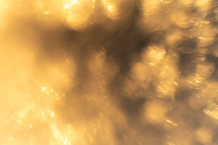 The bokeh is bright yellow. Abstraction with bright sunbeams and flaresの写真素材