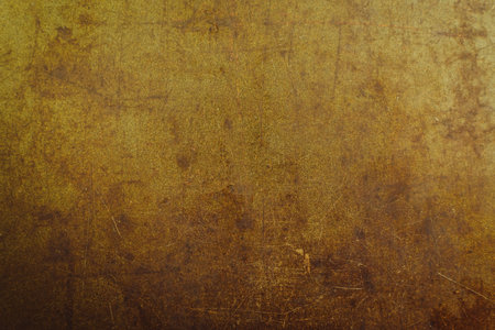 Dark golden abstract background with scuffs and scratches. metal texture with rust