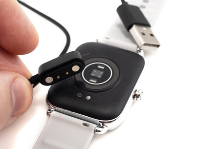 Magnetic charger for smart watch. Watches for fitness and monitoring the well-being of the human...