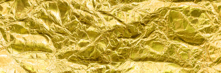 Texture of crumpled, crumpled foil of golden, yellow color. Foil banner website