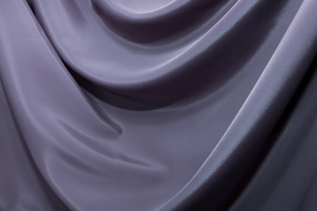 The texture of a luxurious smooth fabric in blue, purple with folds and waves. Blue fabric, materialの写真素材