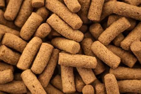 Food for animals and aquarium fish in grits on a white background. Pile of feed