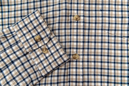 Men's shirt. Plaid shirt sleeve with buttons. Piece of clothing. button