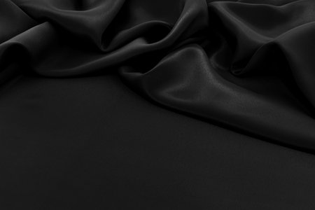 Texture of satin or silk fabric in black color. Textile. Fabric background with folds and wavesの写真素材
