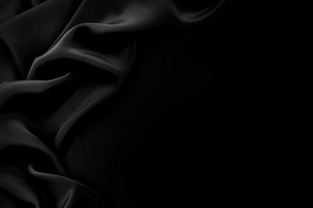 Texture of satin or silk fabric in black color. Textile. Fabric background with folds and wavesの写真素材