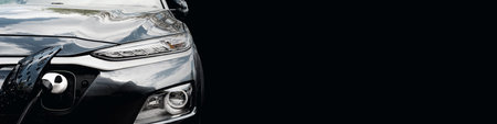 Electric car at the charging station background with free space in black color for the site. Ecology. Eco friendly transportの写真素材