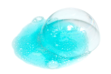 Spilled shampoo or liquid soap on a white background. Foam with large and small bubbles of detergent. hand sanitizerの写真素材