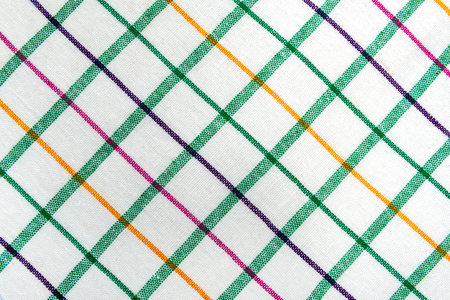 The texture of linen fabric in a large cell of green and white. Scottish tailoring material