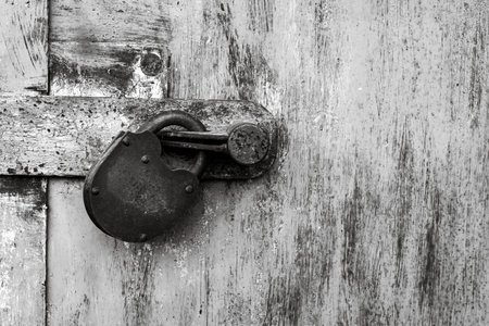 Old rusty lock on metal doors. Lock on the door with an empty place for an inscription