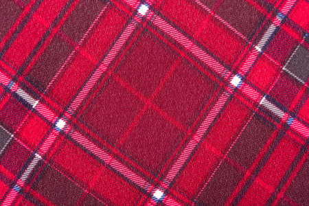 The texture of linen fabric in a large cell of red and white. Scottish tailoring material. checkered...