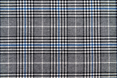 The texture of linen fabric in a large cell of black, blue and white. Scottish tailoring material. checkered fabricの写真素材