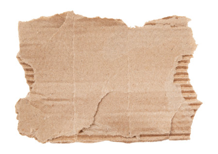 A piece of textured packaging cardboard. Piece of torn cardboard with copy space. Brown wrapping vintage paper, isolated top view. Kraft paper isolated on white backgroundの写真素材