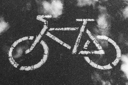 A bike path sign is painted on the asphalt. Bicycle as a sign on the roadの写真素材
