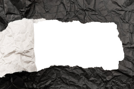 Black paper background with copy space. Hole on a crumpled dark sheetの写真素材