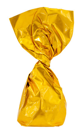 Sweet candy in yellow foil on a white background. foil paperの写真素材