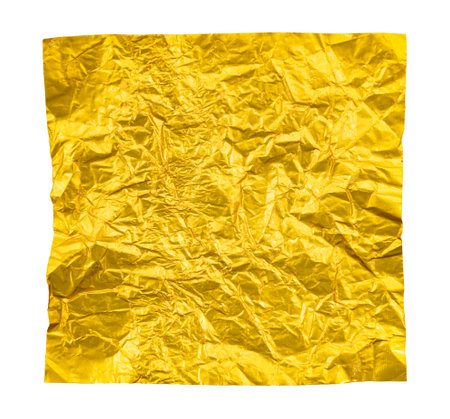 A piece of crumpled yellow foil on a white background. Foilの写真素材