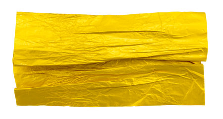 A piece of crumpled yellow foil on a white background. Foilの写真素材