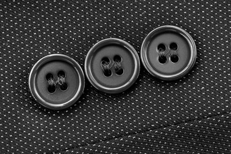 Close-up of black buttons on the sleeve of a man's jacket. Man's jacket. Button