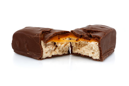 Chocolate bar with nougat on a white background. The candy bar is broken in halfの写真素材