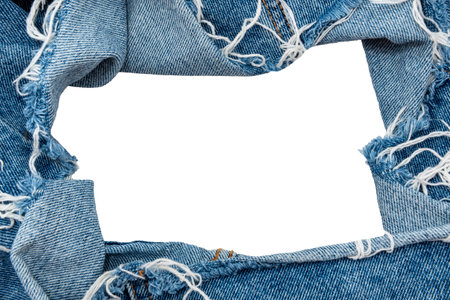 Hole in denim on a white background. Ripped jeansの写真素材