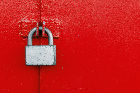 Padlock on a steel red door. Lock on the gate. Safetyの写真素材