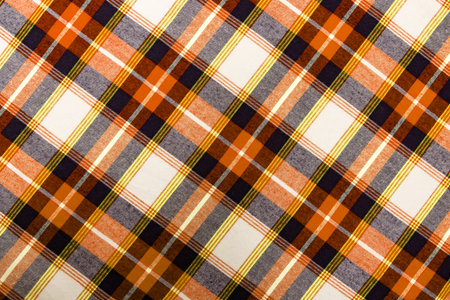 The texture of linen fabric in a large cage of blue, red, yellow and white. Scottish tailoring material. Checkered fabricの写真素材