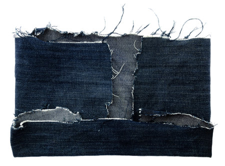 Piece of torn denim on a white background. Denim texture