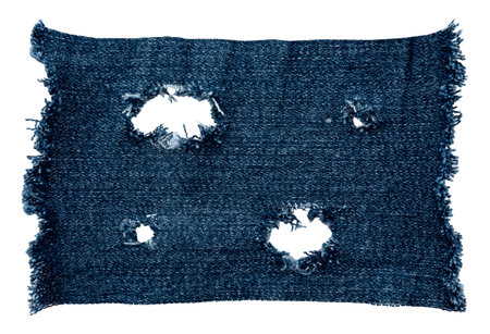 Piece of torn denim on a white background. Denim texture