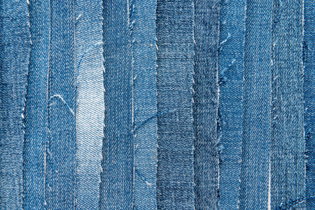 Texture from torn pieces of denim. Jeans texture. Material for sewing clothes