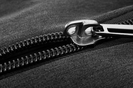 Silver lock with black zipper on clothes close-up. Zipperの写真素材