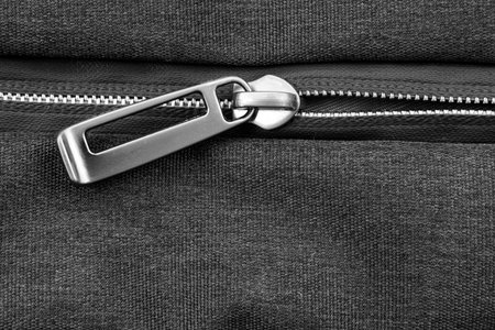 Silver lock with black zipper on clothes close-up. Zipper
