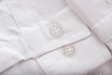 Close-up of white shirt sleeve with buttons. White men's shirt